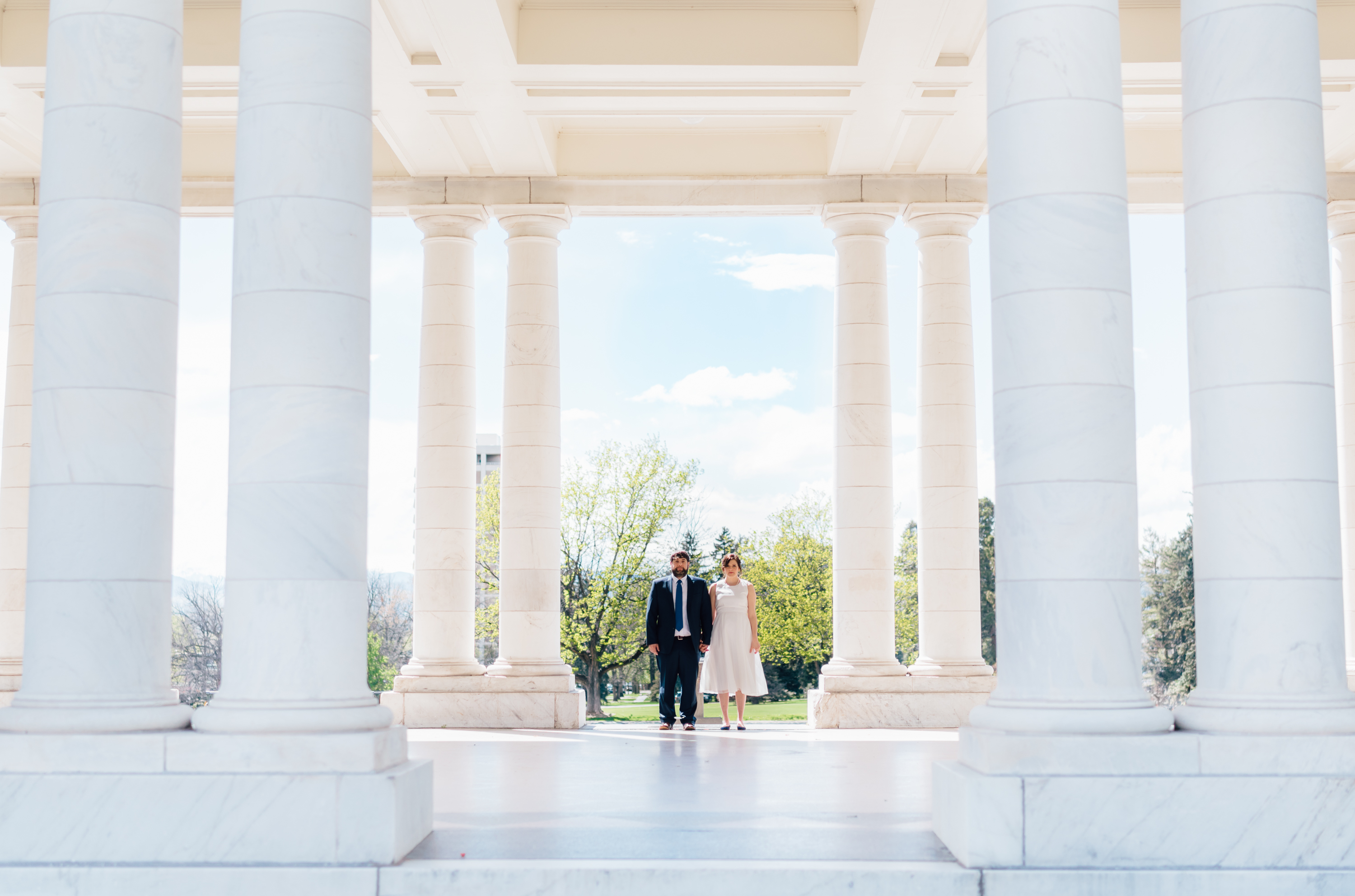 Couple in front of pillars at Cheesman Park